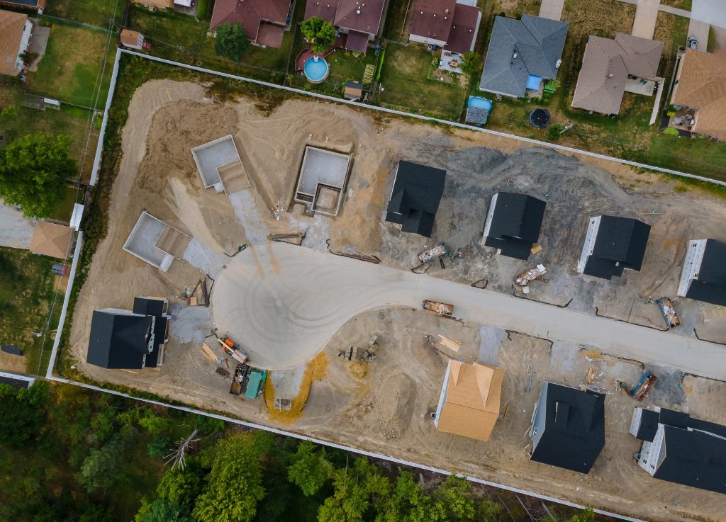 A residential aerial view of new housing development being built of a new home under construction